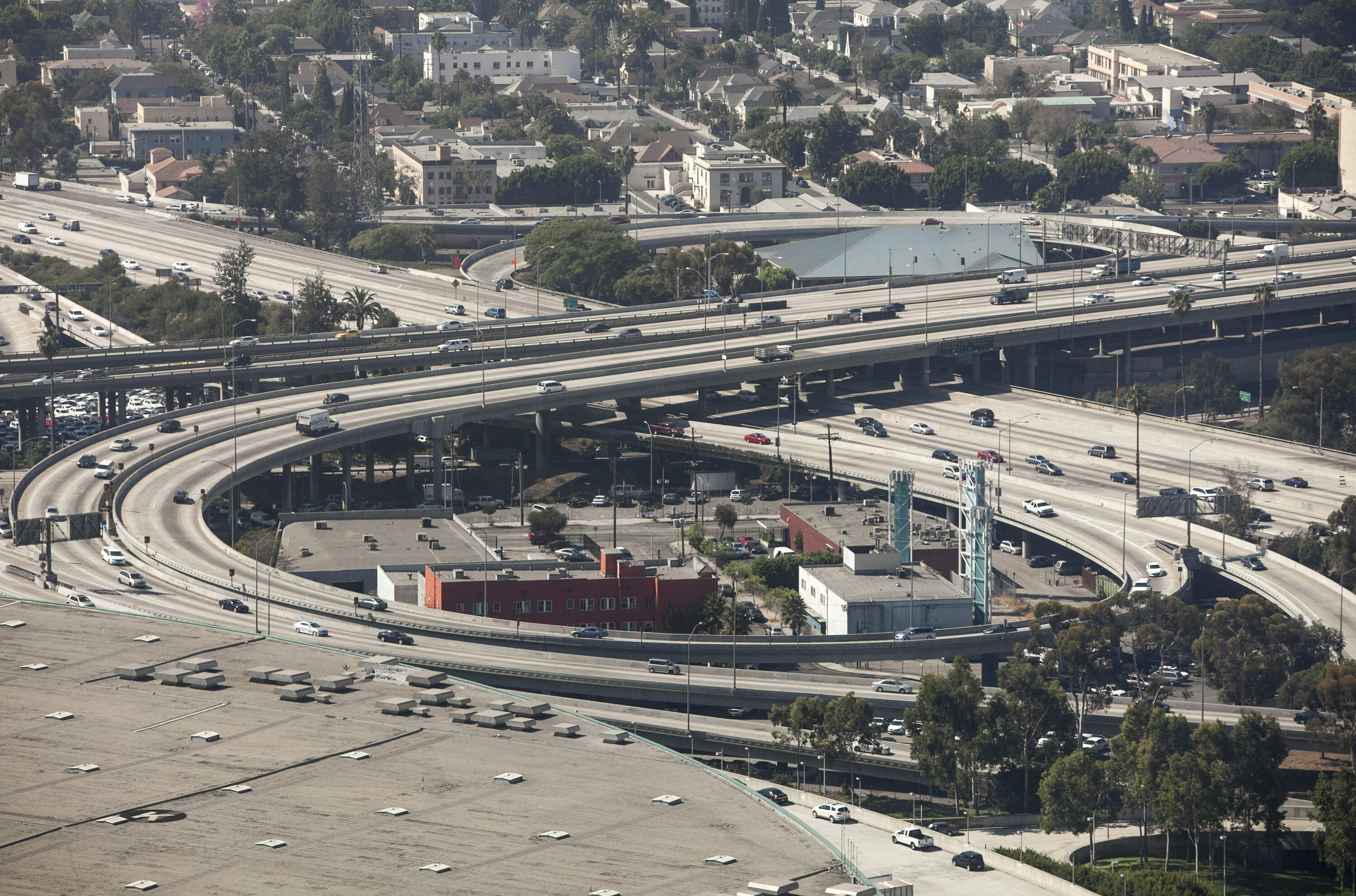 Interstates 10 and 110 stand next to the Los Angeles Convention Center, bottom left, in Los Angeles. (Damian Dovarganes)