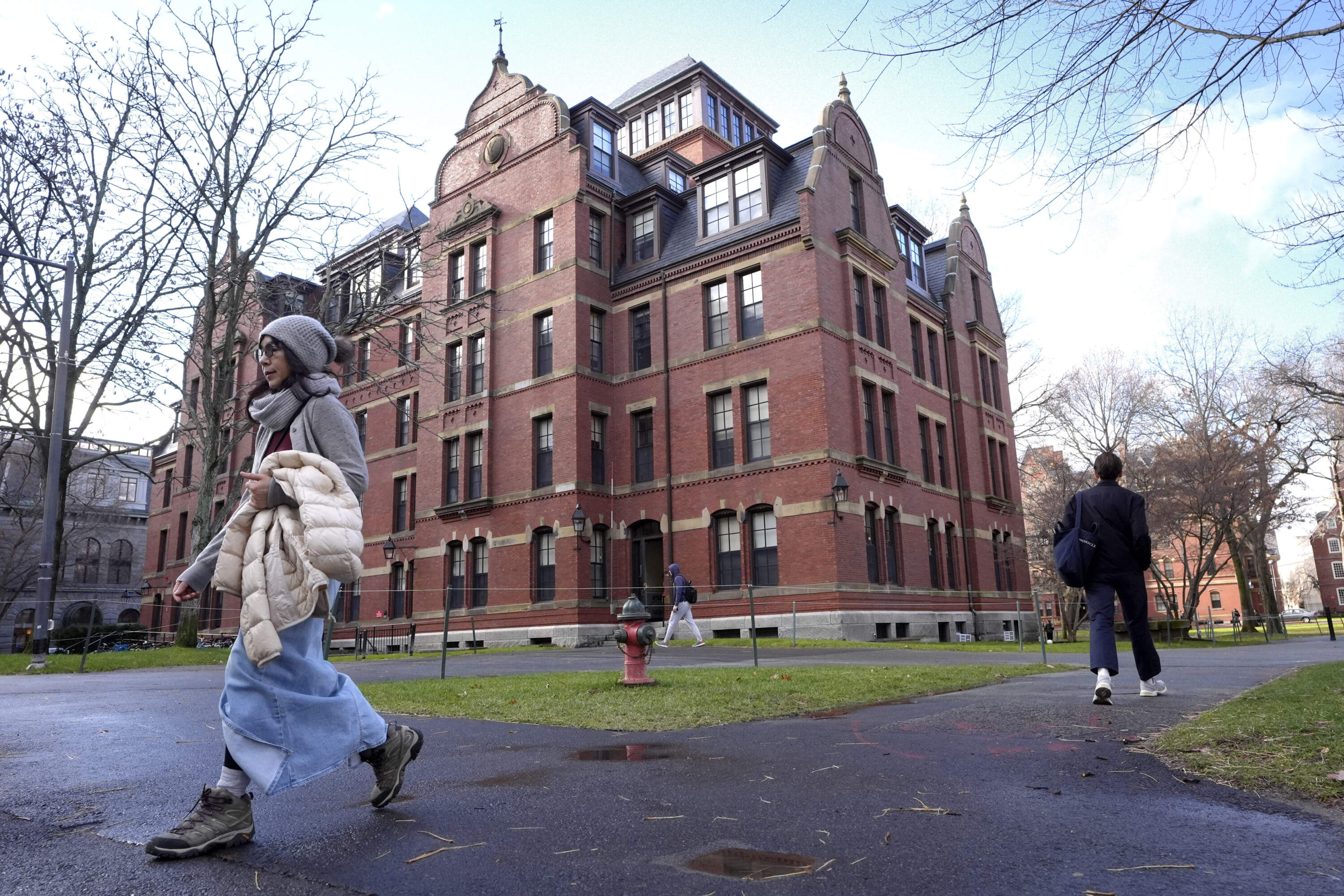 People walk between buildings on the campus of Harvard University in Cambridge, Mass. Dec. 17, 2024. (Steven Senne/AP)