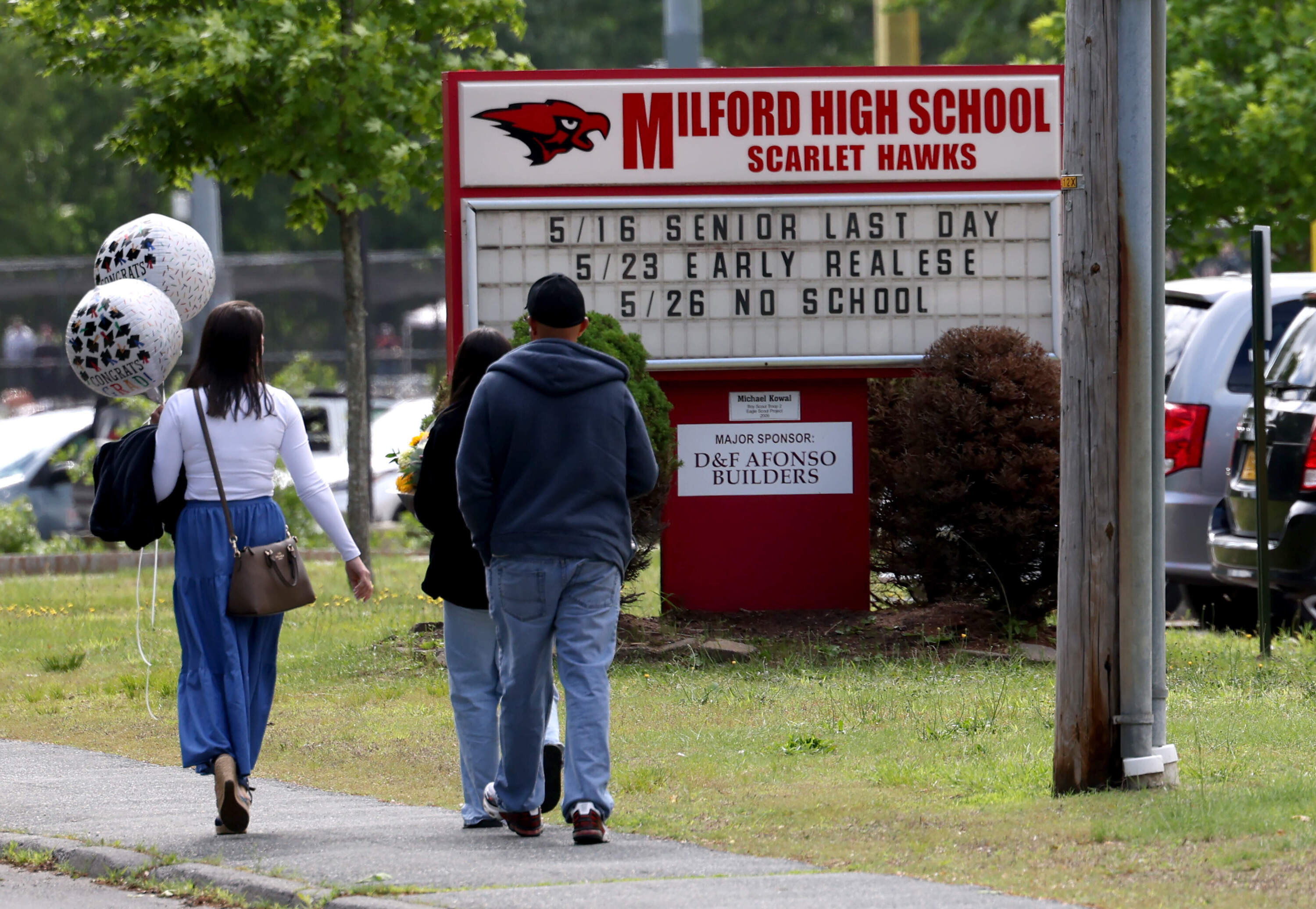 People walked to Milford High School's graduation ceremony on June 1, 2025. (Jessica Rinaldi/The Boston Globe via Getty Images)