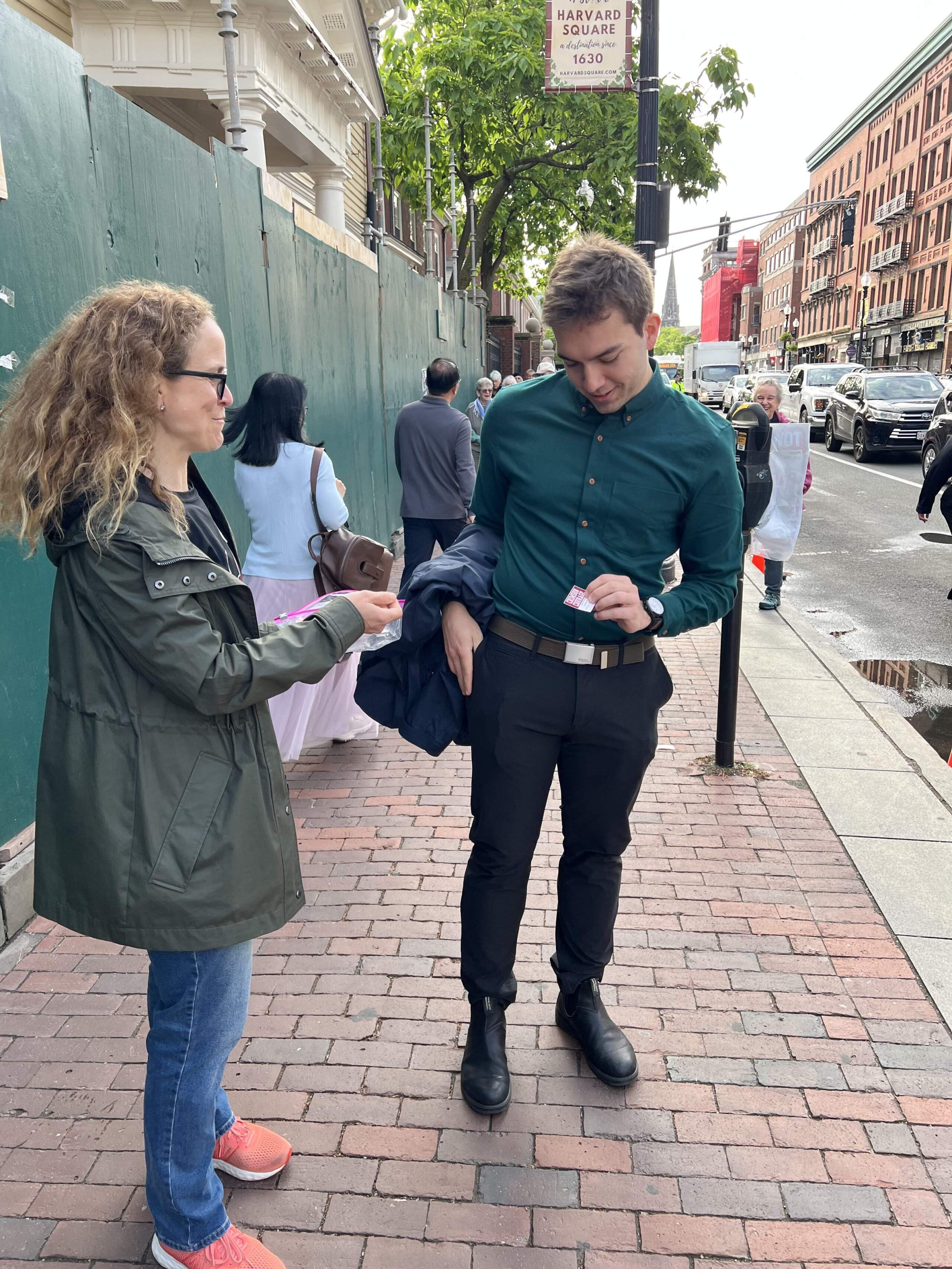 A Crimson Courage volunteer passes out stickers near Harvard's campus. (Courtesy Lisa Paige)
