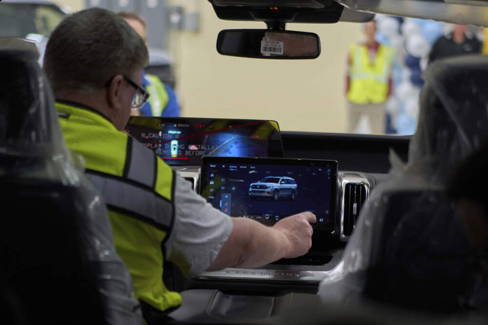 A worker demonstrates controlls on a 2025 Ford Expedition during a media tour at the Ford Motor Company Kentucky Truck Plant to launch the 2025 Ford Expedition, Wednesday, April 30, 2025, in Louisville, Ky. (AP Photo/Carolyn Kaster)