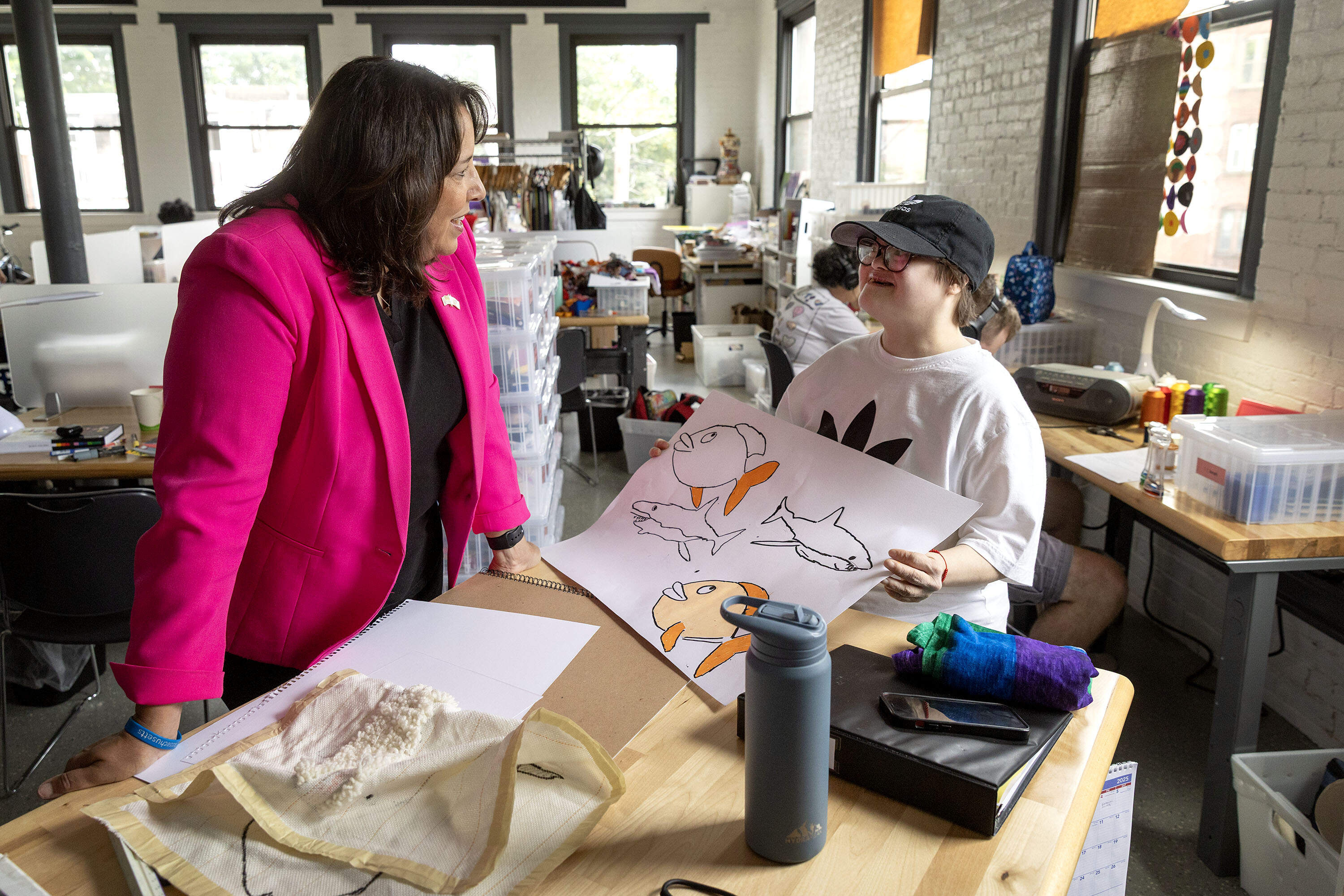 Lt. Gov. Kim Driscoll talks with artist Carmen Martinez at the opening of Gateway Arts in Brookline. (Robin Lubbock/WBUR)