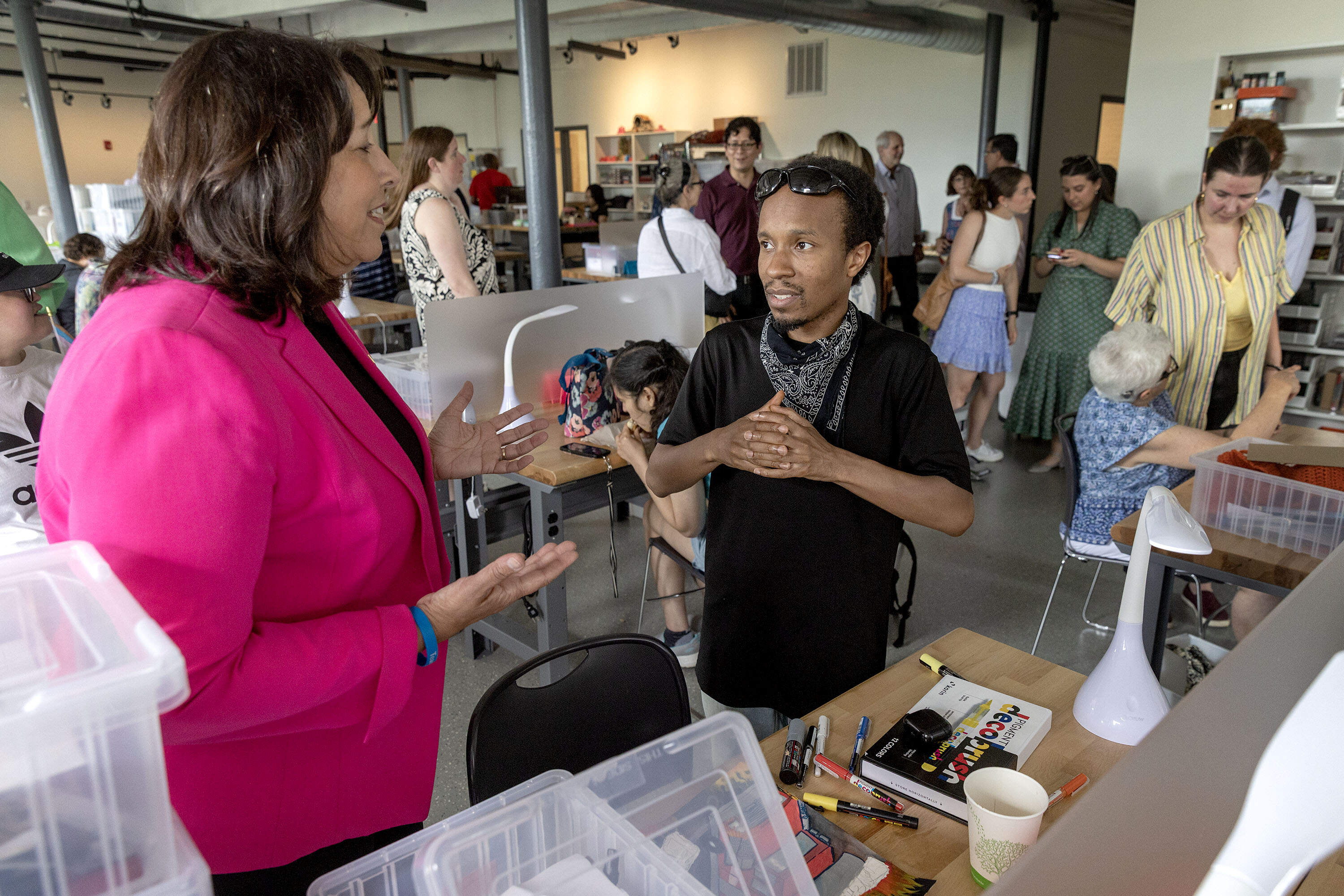 Lt. Gov. Kim Driscoll talks with artist Chuck Johnson at the opening. (Robin Lubbock/WBUR)