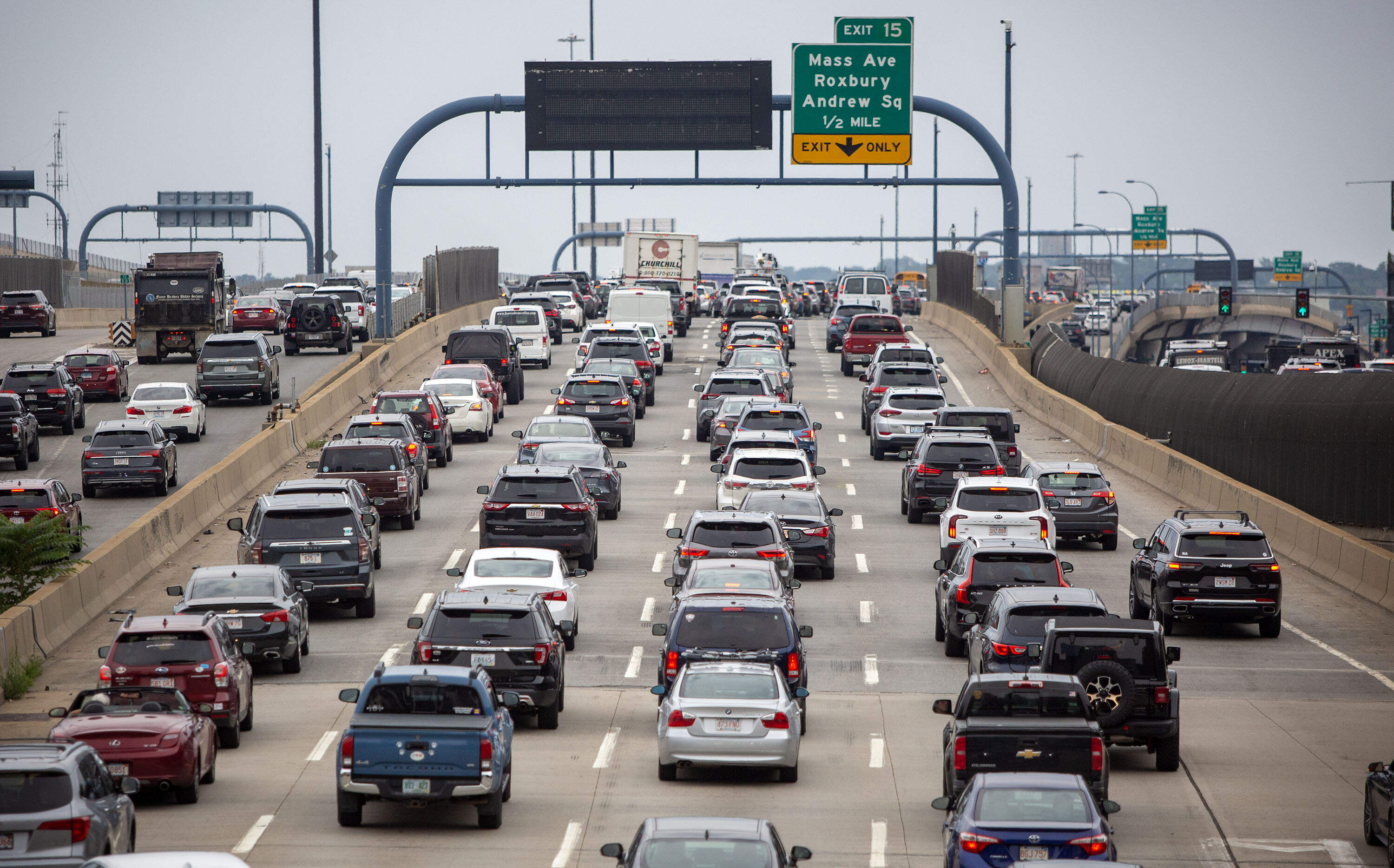Cars crawl along I-93 South out of Boston, in mid-afternoon traffic congestion.