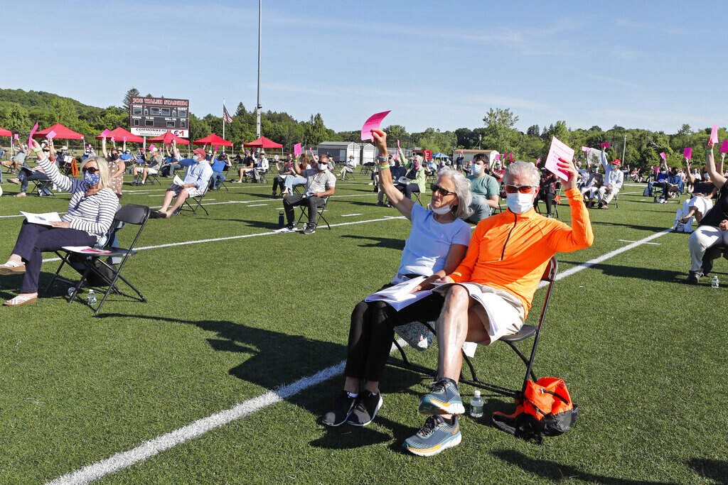 In 2020, North Andover held its annual town meeting on the high school football field. It was the first ever outdoor town meeting since North Andover was established in 1646. (Elise Amendola/AP)