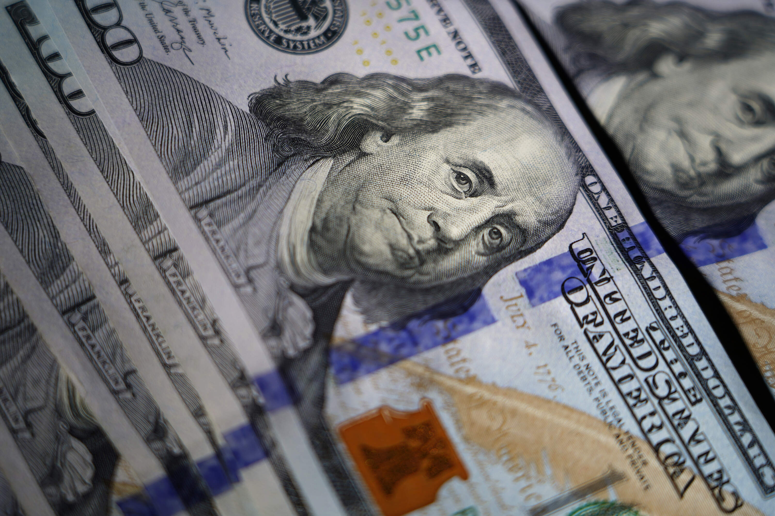 The likeness of Benjamin Franklin is seen on U.S. $100 bills. (Matt Slocum/AP)