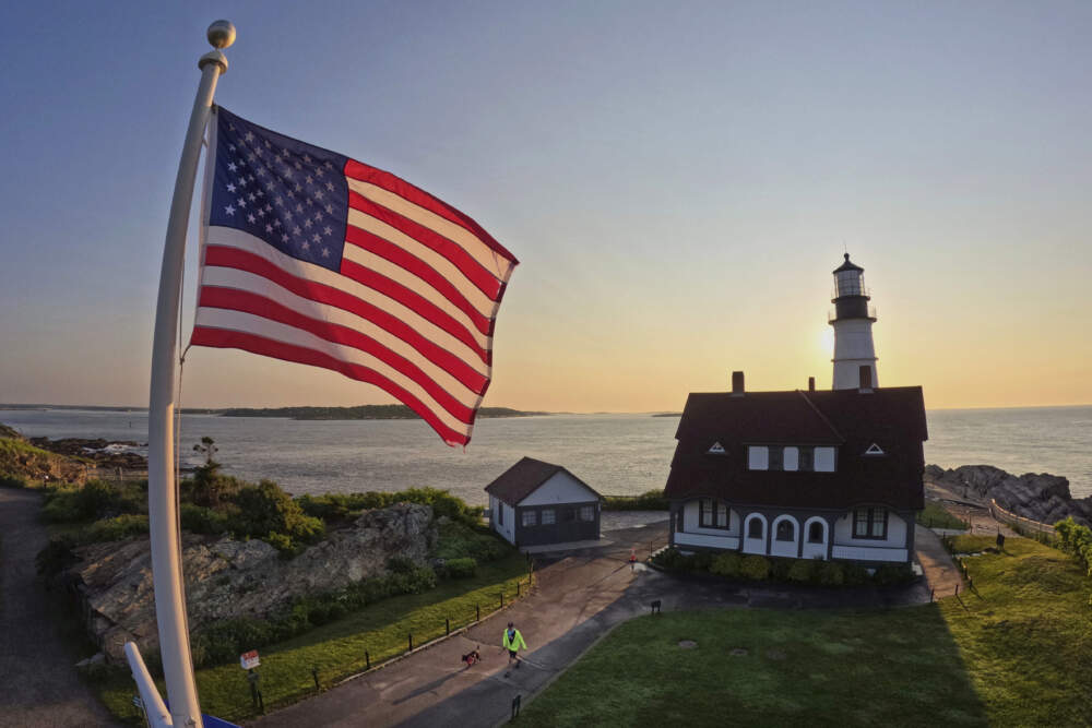 An American flag at Portland Head Light catches the light at sunrise, Wednesday, June 11, 2025, in Cape Elizabeth, Maine. (Robert F. BukatyAP)