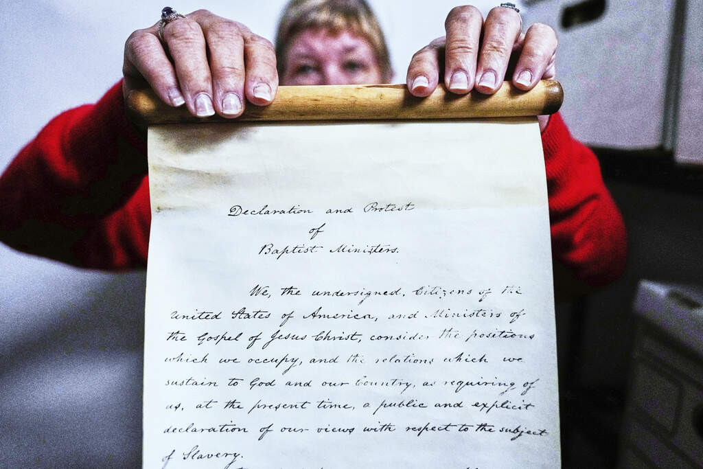 Historian Jennifer Cromack holds the scroll. (Charles Krupa/AP)