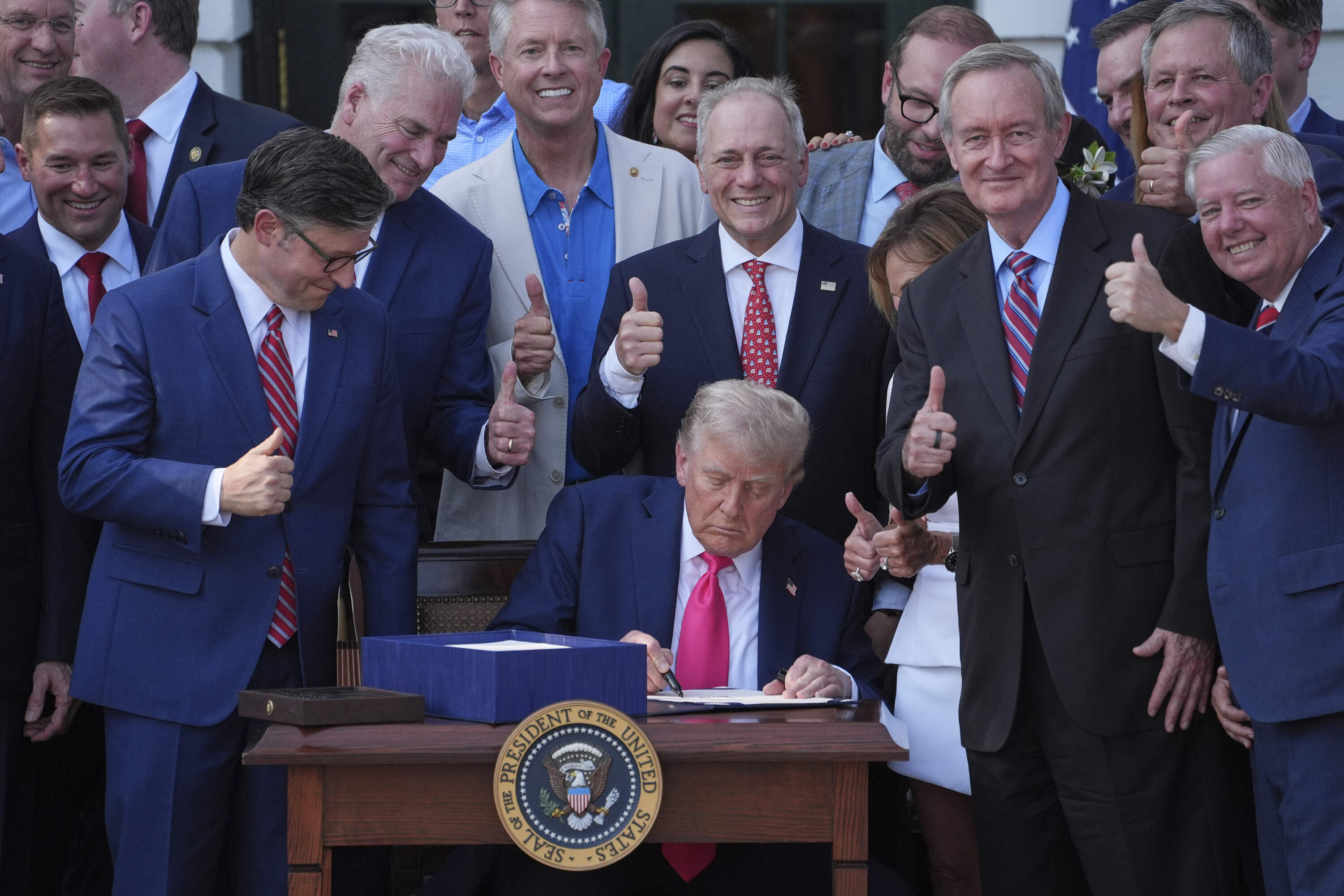 President Donald Trump signs his signature bill of tax breaks and spending cuts at the White House, Friday, July 4, 2025. (Evan Vucci/AP)