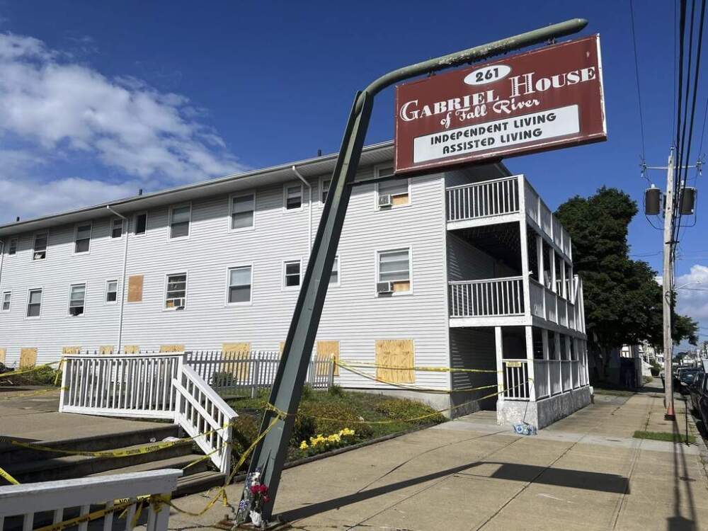Boards cover the windows of the Gabriel House assisted living facility in Fall River on Tuesday. (Kimberlee Kruesi/AP)