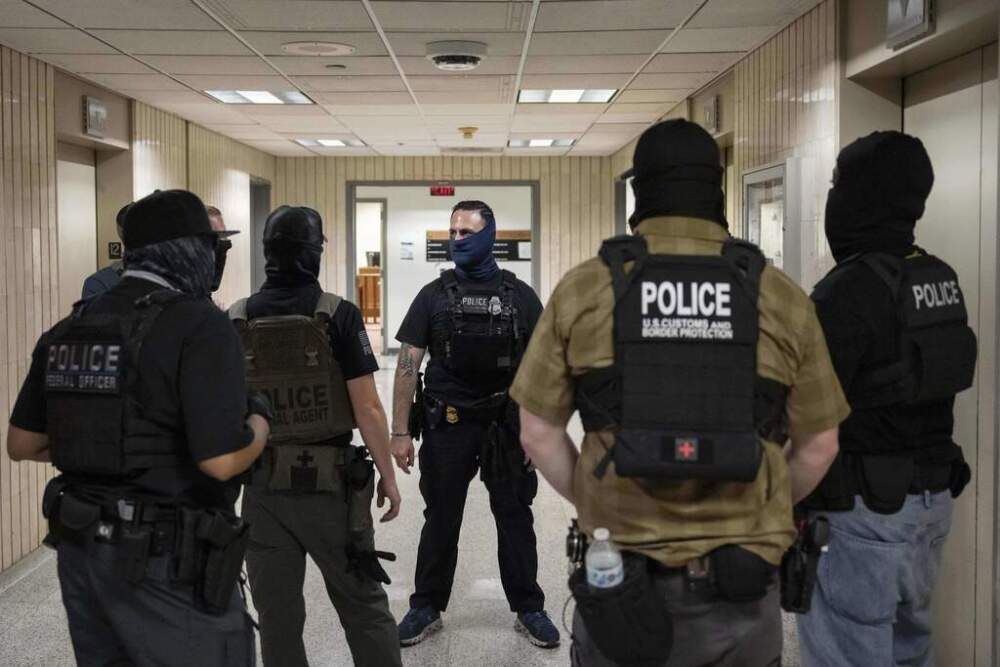 Federal agents stand outside an immigration court in New York on July 17. (Yuki Iwamura/AP)