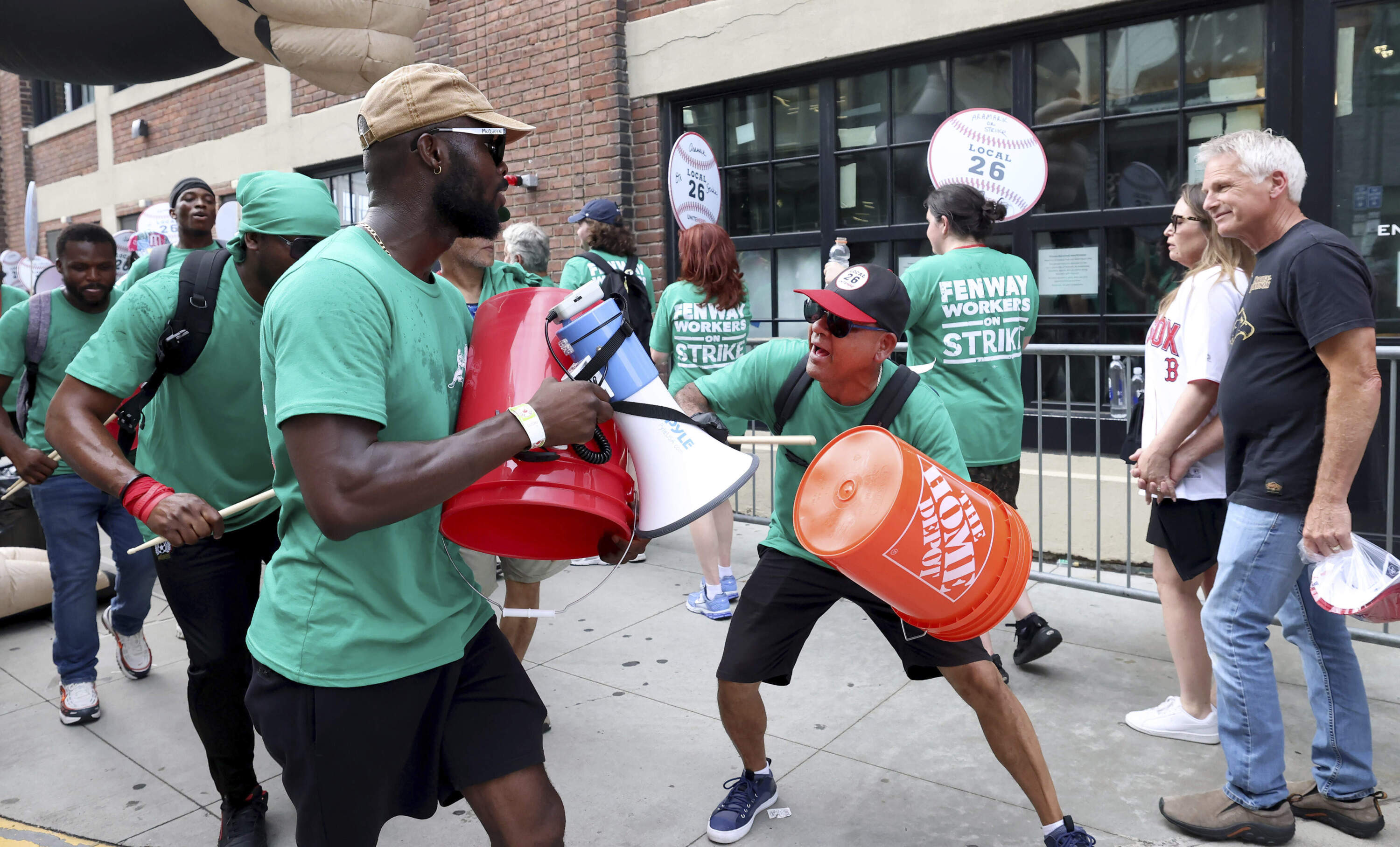 Concession workers from Fenway Park picket outside the ballpark Friday, July 25, 2025, in Boston before a baseball game between the Boston Red Sox and the Los Angeles Dodgers. (AP Photo/Mark Stockwell)