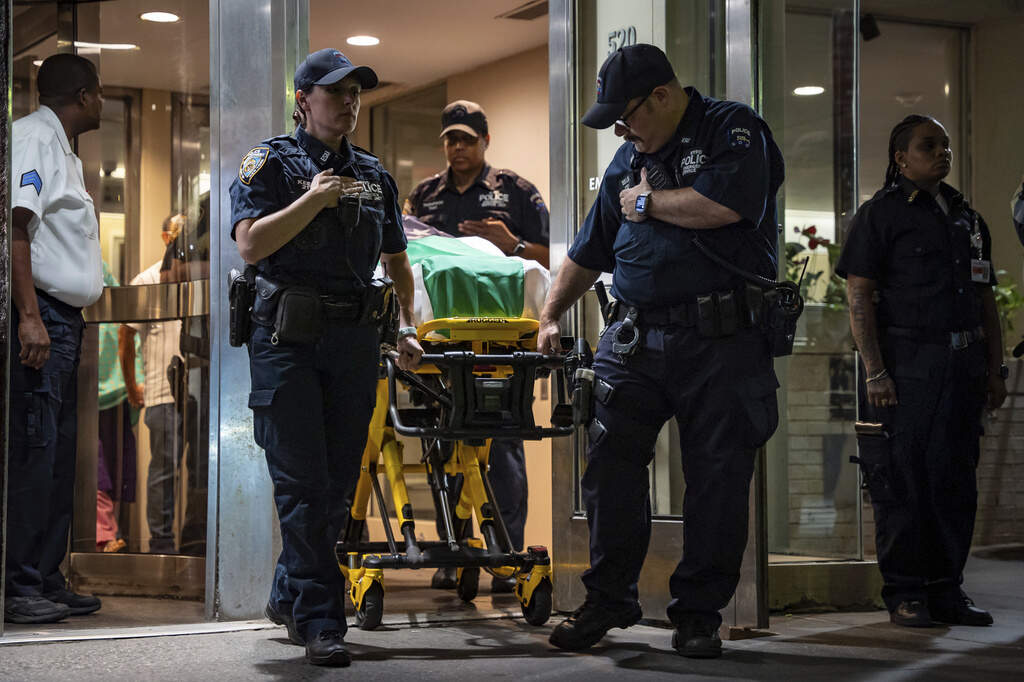 NYPD officers bring out the body of Didarul Islam, who was shot and killed by a gunman earlier this evening, during his dignified transfer of out of NewYork-Presbyterian/Weill Cornell Medical Hospital to the medical examiner's office, early Tuesday, July 29, 2025, in New York. (AP Photo/Angelina Katsanis)