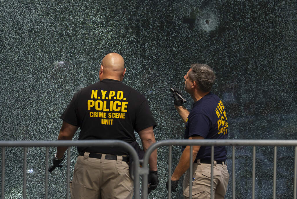Members of NYPD Crime Unit examine a door with bullet holes at the scene of Monday's deadly shooting, Tuesday, July 29, 2025, in New York. (Yuki Iwamura/AP)