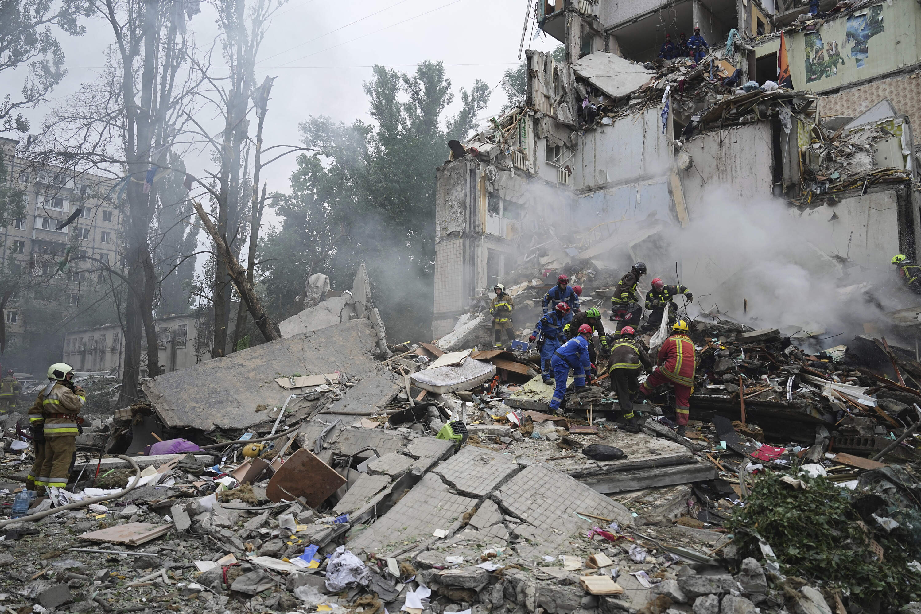 Rescuers work in a destroyed apartment building after a Russian missile attack in Kyiv, Ukraine, Thursday, July 31, 2025. (Efrem Lukatsky/AP)
