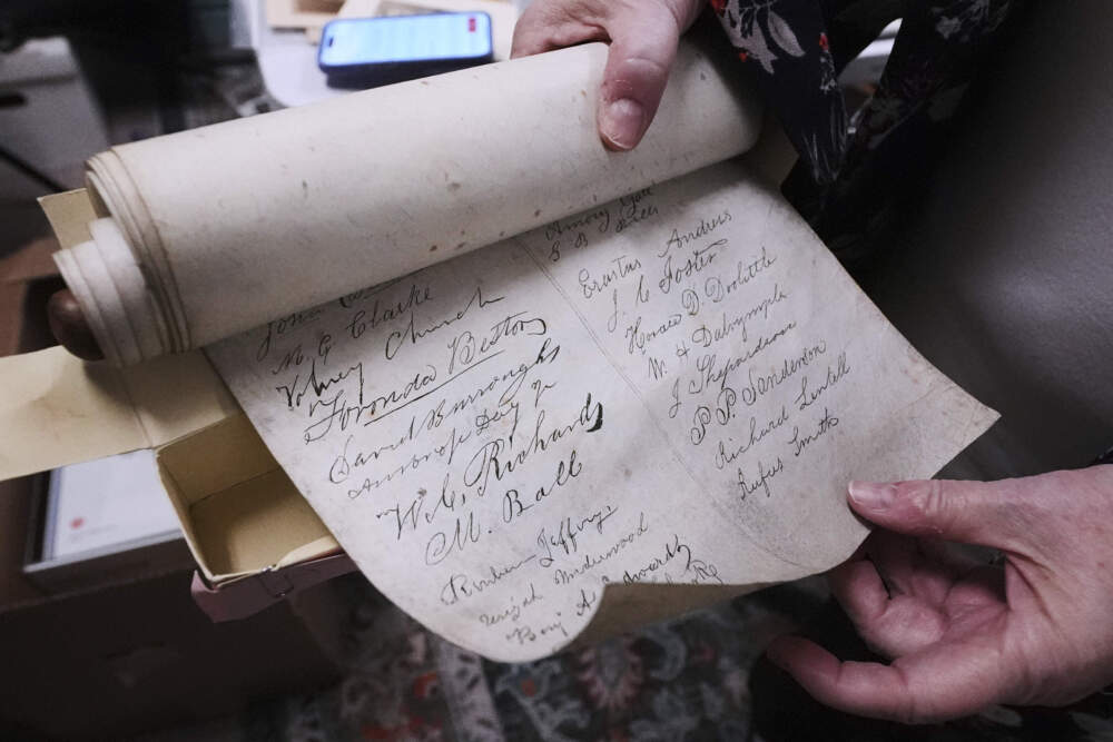 Rev. Diane Badger shows signatures on a 178-year-old anti-slavery scroll in Groton, Mass. (Charles Krupa/AP)