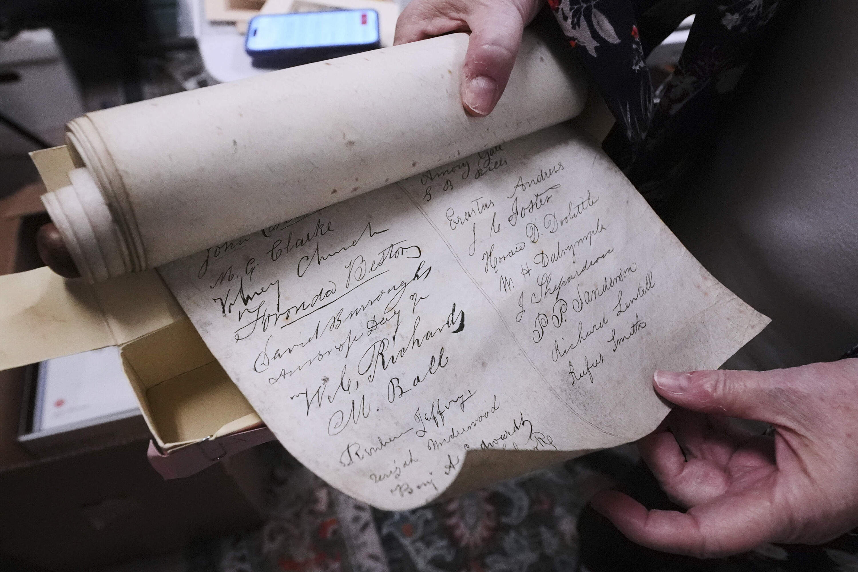 Rev. Diane Badger shows signatures on a 178-year-old anti-slavery scroll in Groton, Mass. (Charles Krupa/AP)