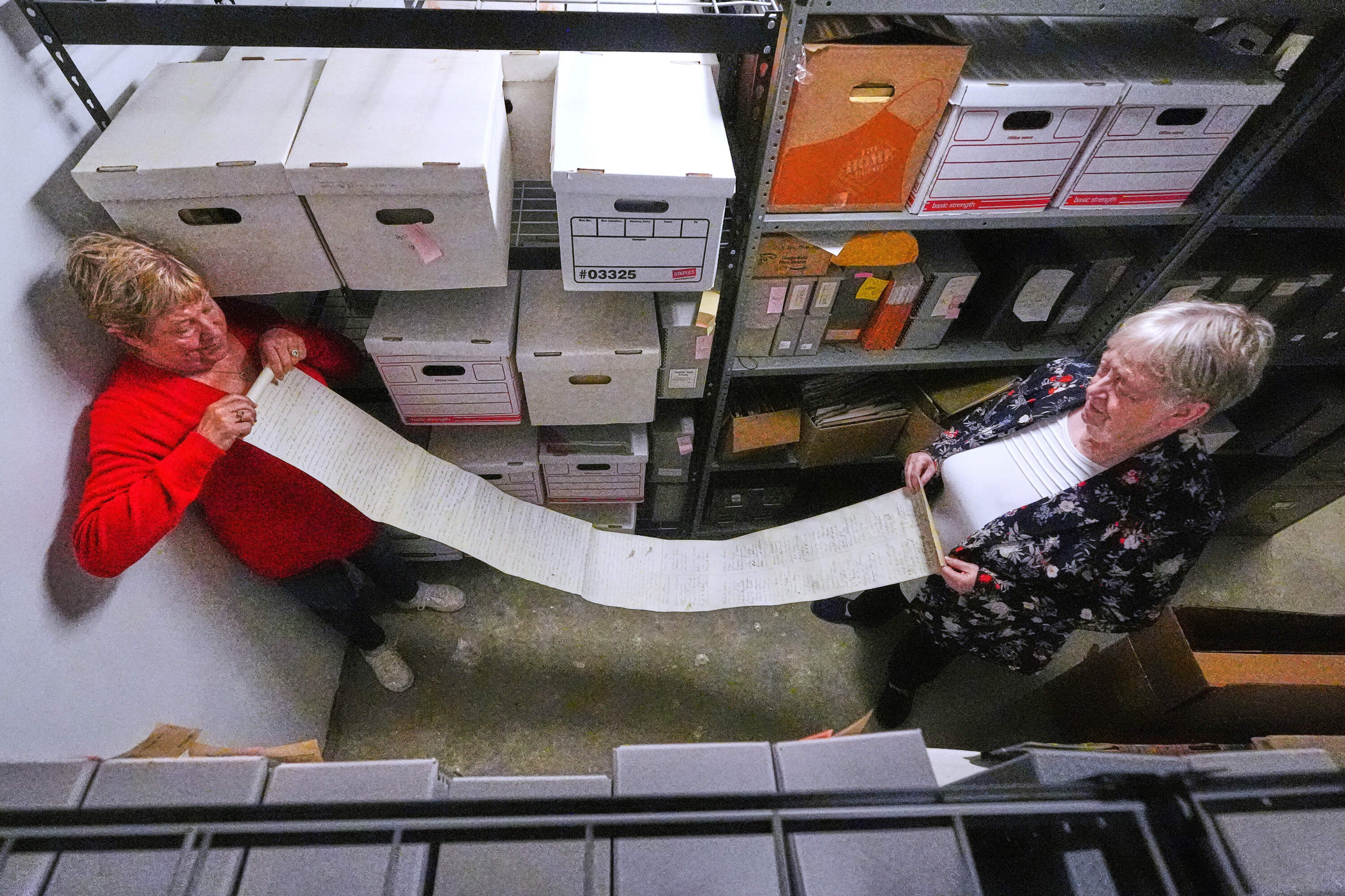 Historian Jennifer Cromack, left, and Rev. Diane Badger unfurl the 5-foot-long anti-slavery scroll. (Charles Krupa/AP)