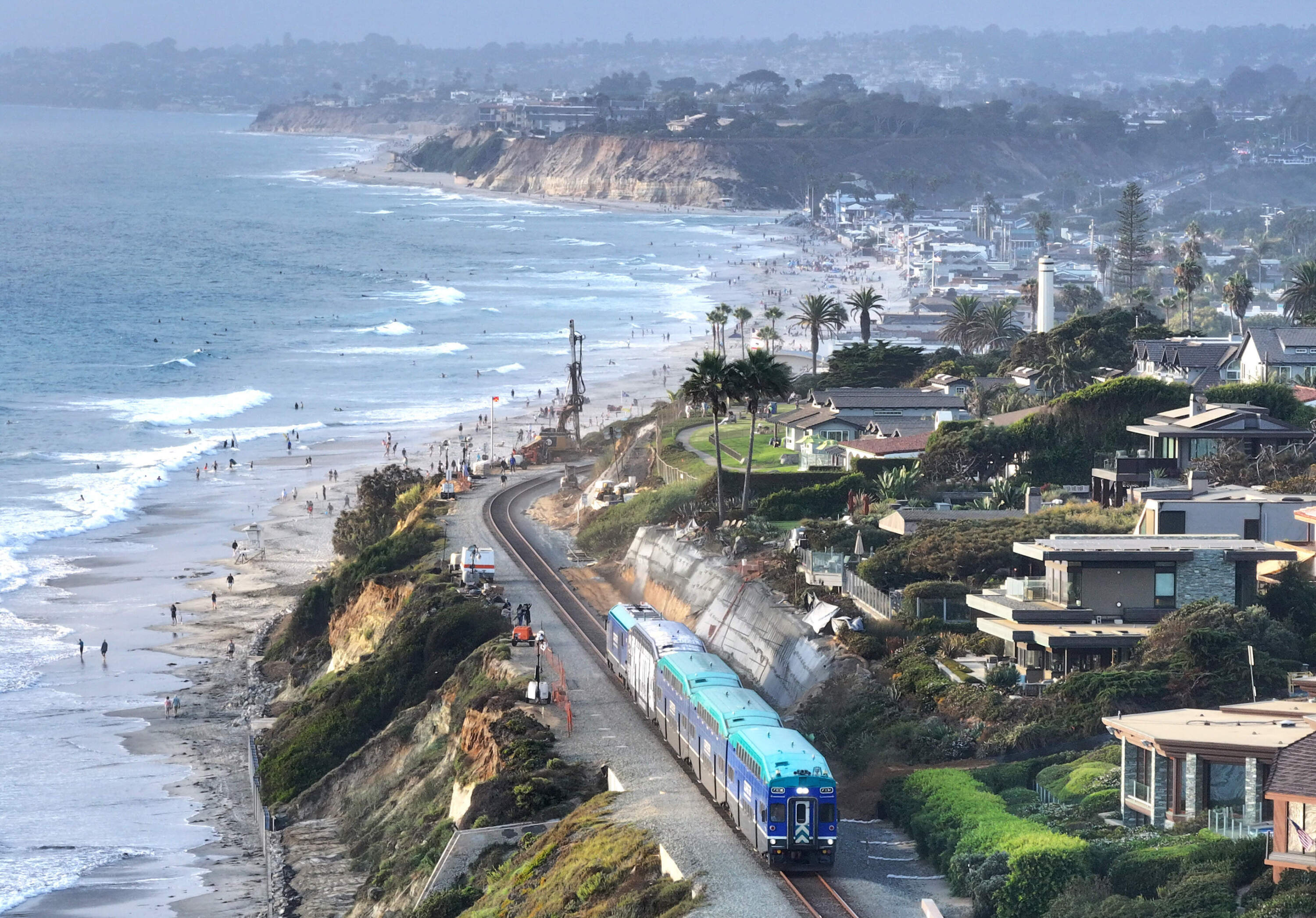 An aerial view of a Coaster commuter train passing along eroding cliffs at the Pacific Ocean coastline on August 16, 2024 in Del Mar, California. (Mario Tama/Getty Images)