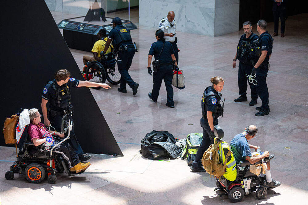 U.S. Capitol Police arrest protesting members of American Disabled for Attendant Programs Today (ADAPT) in the atrium of the Hart Senate Office Building on Tuesday, June 24. (Bill Clark/CQ-Roll Call, Inc via Getty Images)