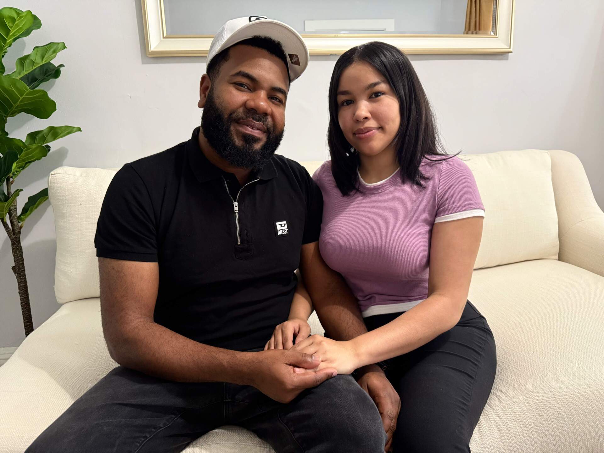 Kary Diaz Martinez and her husband, Wiliz de Leon, in their Providence, R.I., apartment. (WBUR/Miriam Wasser)
