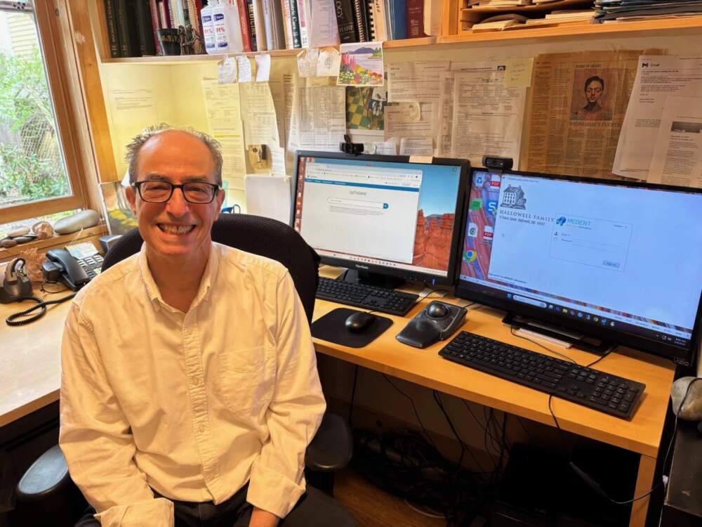 Dr. Scott Schiff-Slater sits at his desk in Hallowell, Maine. (Patty Wight/Maine Public)