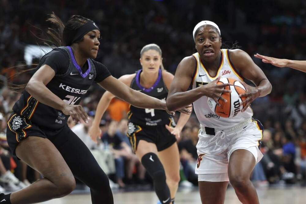 Indiana Fever's Aari McDonald drives past Connecticut Sun's Aneesah Morrow during the first half of a game in Boston. (Michael Dwyer/AP)