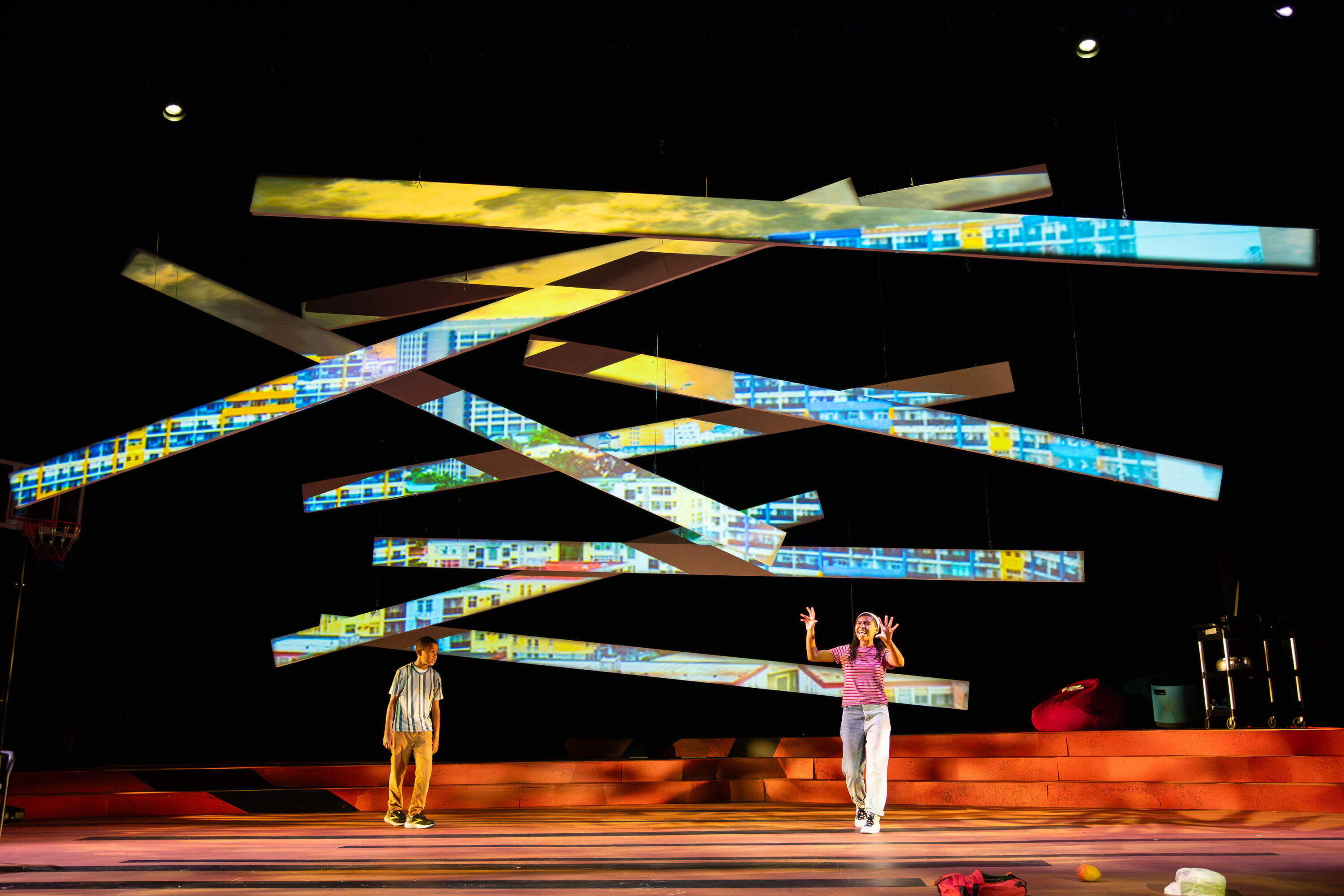 A scene from Mfoniso Udofia's play Kufre n’ Quay, with two characters standing opposite of one another.