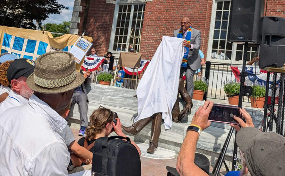 Jeffery Alan Peck prepares to unveil the statue of his great grandfather on July 19, 2025. (Jill Kaufman/NEPM)