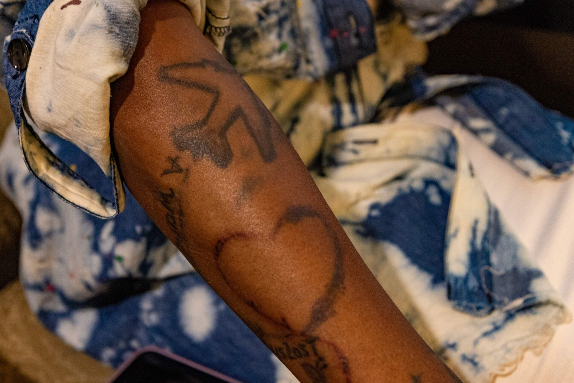 Charisse Pinkney’s tattoo of a plane and a heart connected by a JRR Tolkien-inspired quote. (Jesse Costa/WBUR)