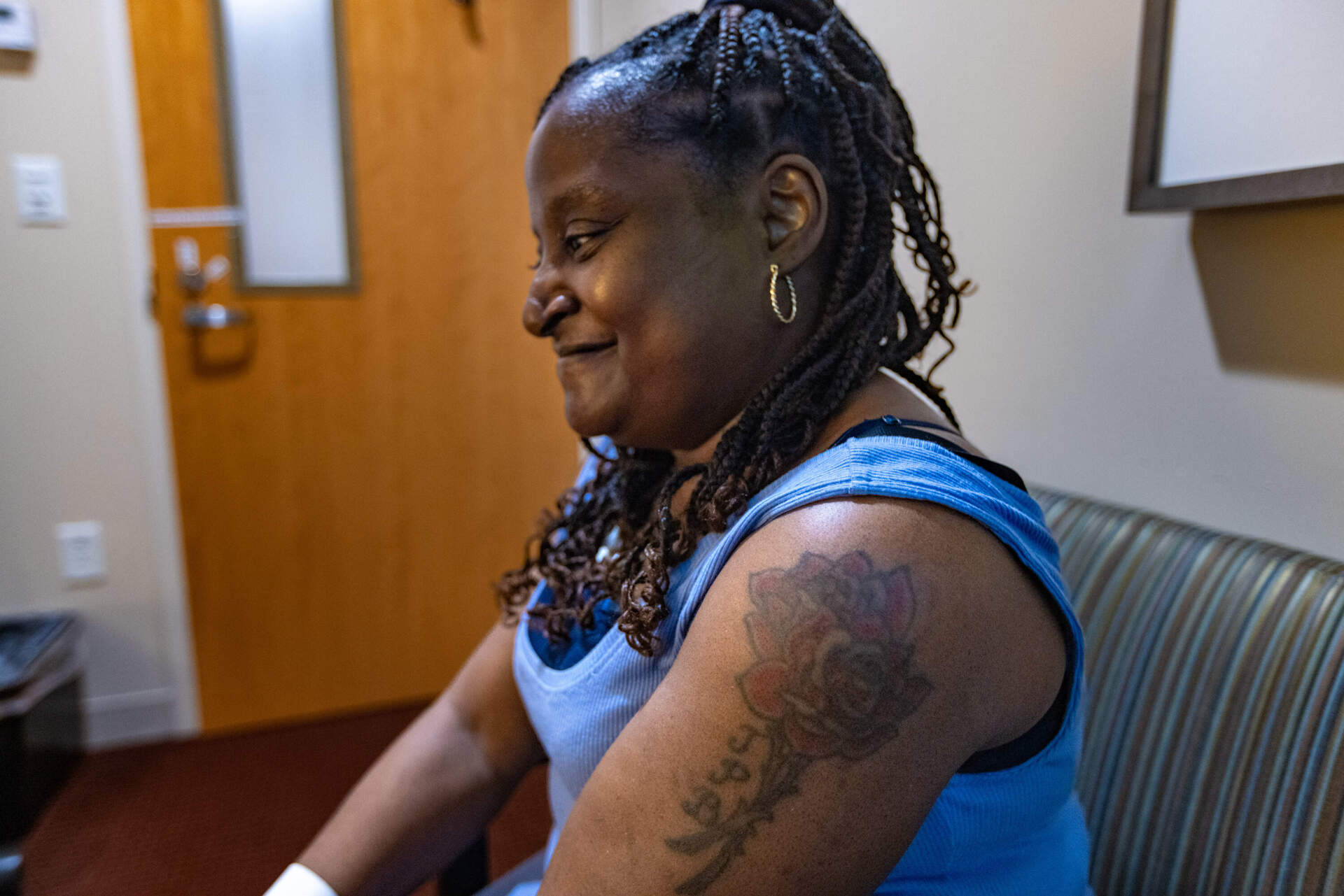 Pearlie Rose Burke smiles as she recalls the first time Dana-Farber Cancer Institute chaplain Larisa Waya saw Burke's tattoo. (Jesse Costa/WBUR)