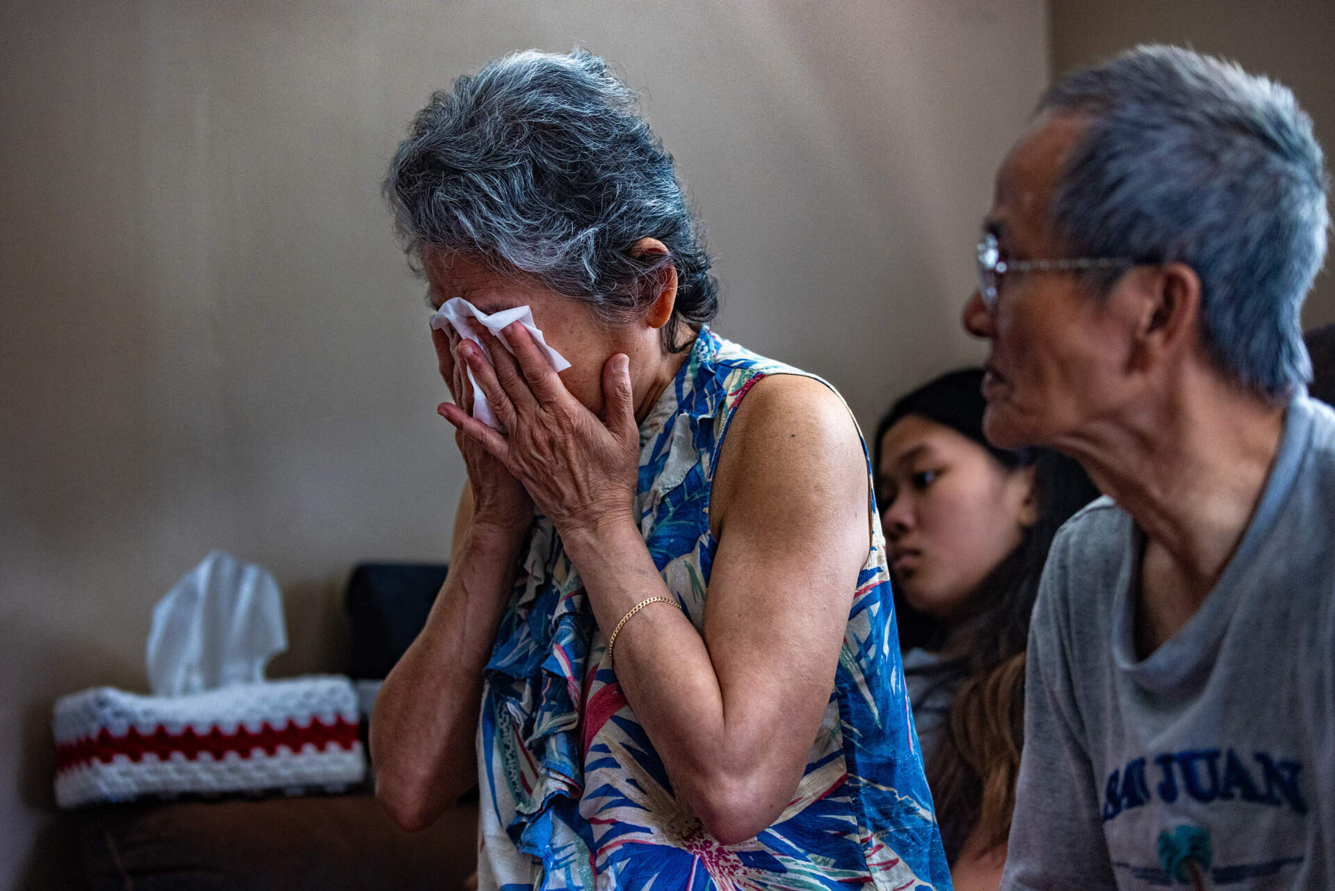 Thearavy Chan wipes her eyes while discussing the violence she faced in Cambodia. (Jesse Costa/WBUR)