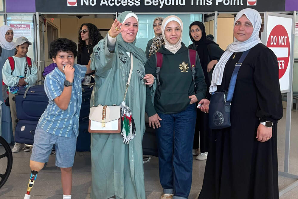 Rahaf Al-Dalou, 14, stands between her aunts and younger cousin. Al-Dalou arrived to Boston from Gaza to get medical care. (Yasmin Amer/WBUR)