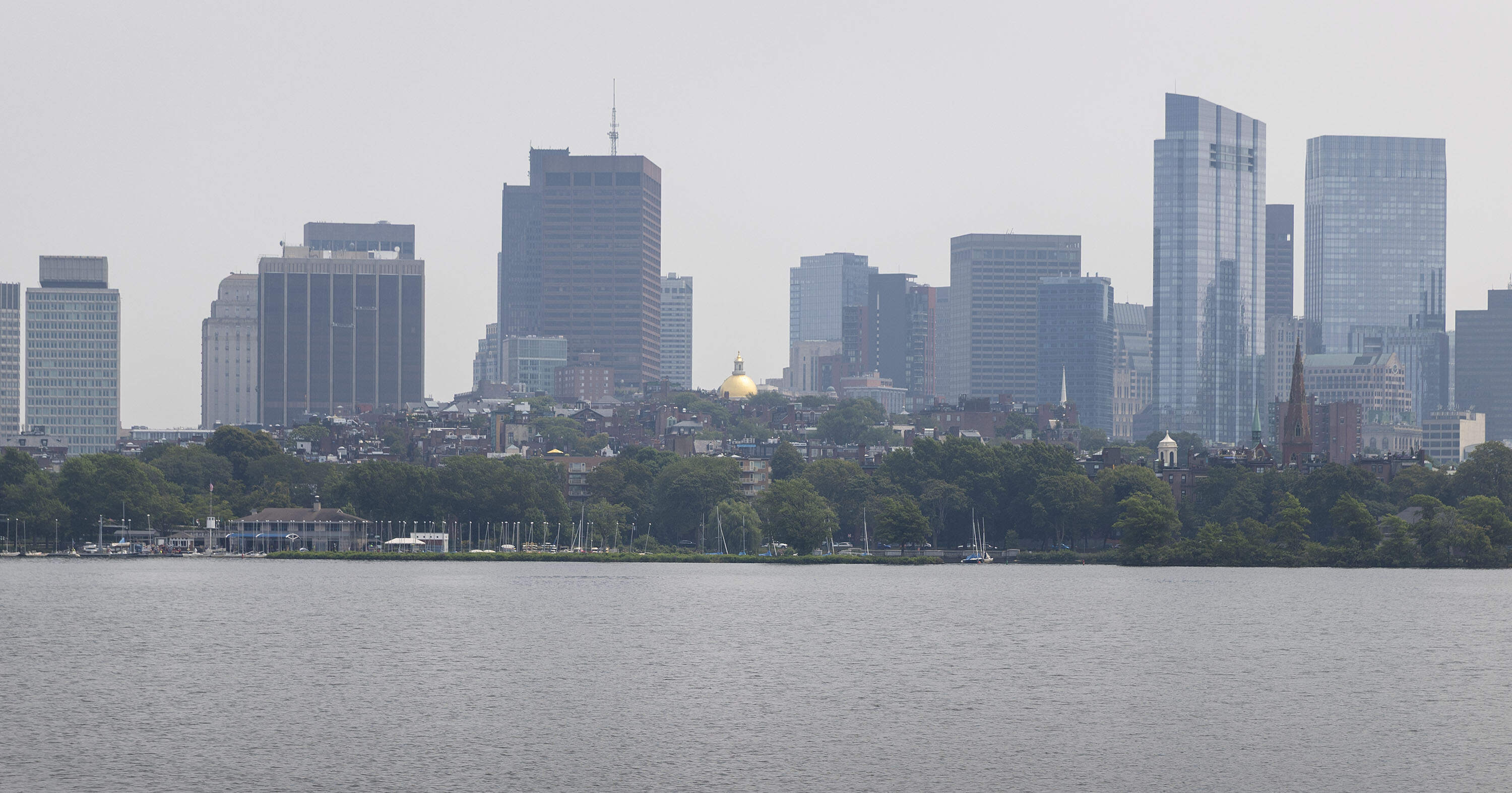 Haze caused by Canadian wildfire smoke hangs over Boston on an August day in 2025. (Robin Lubbock/WBUR)