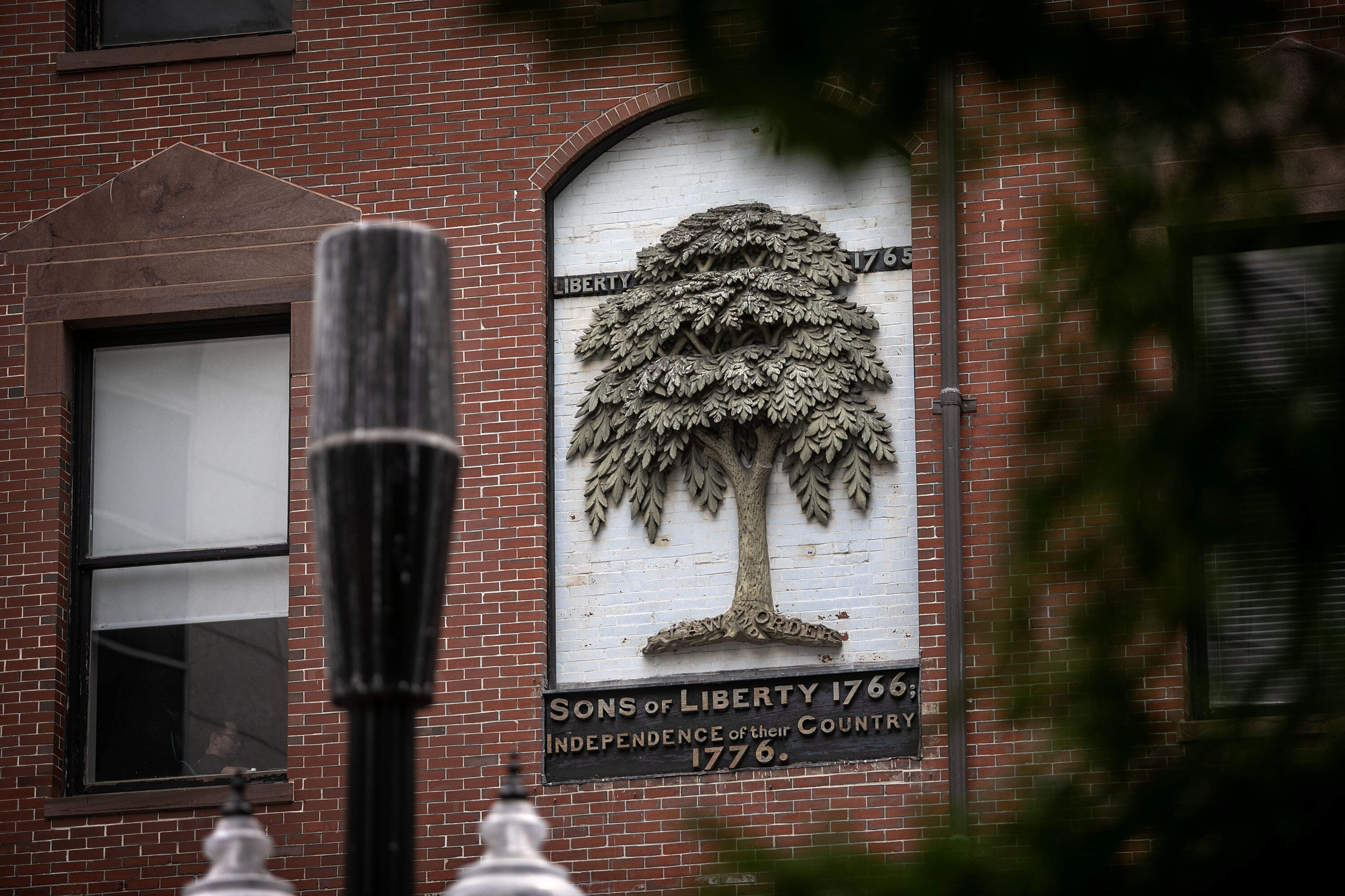 The plaque on Washington St. commemorating the American elm Liberty Tree that once stood in Liberty Tree Plaza in Boston, Mass. (Robin Lubbock/WBUR)