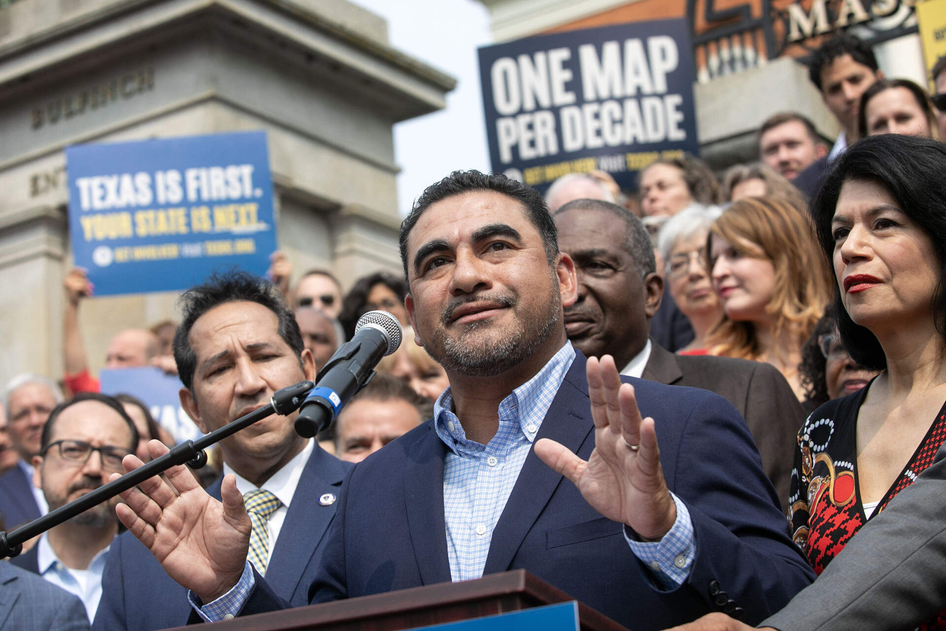 Texas Rep. Armando Walle speaks to people gathered on the steps of the Massachusetts State House. (Robin Lubbock/WBUR)