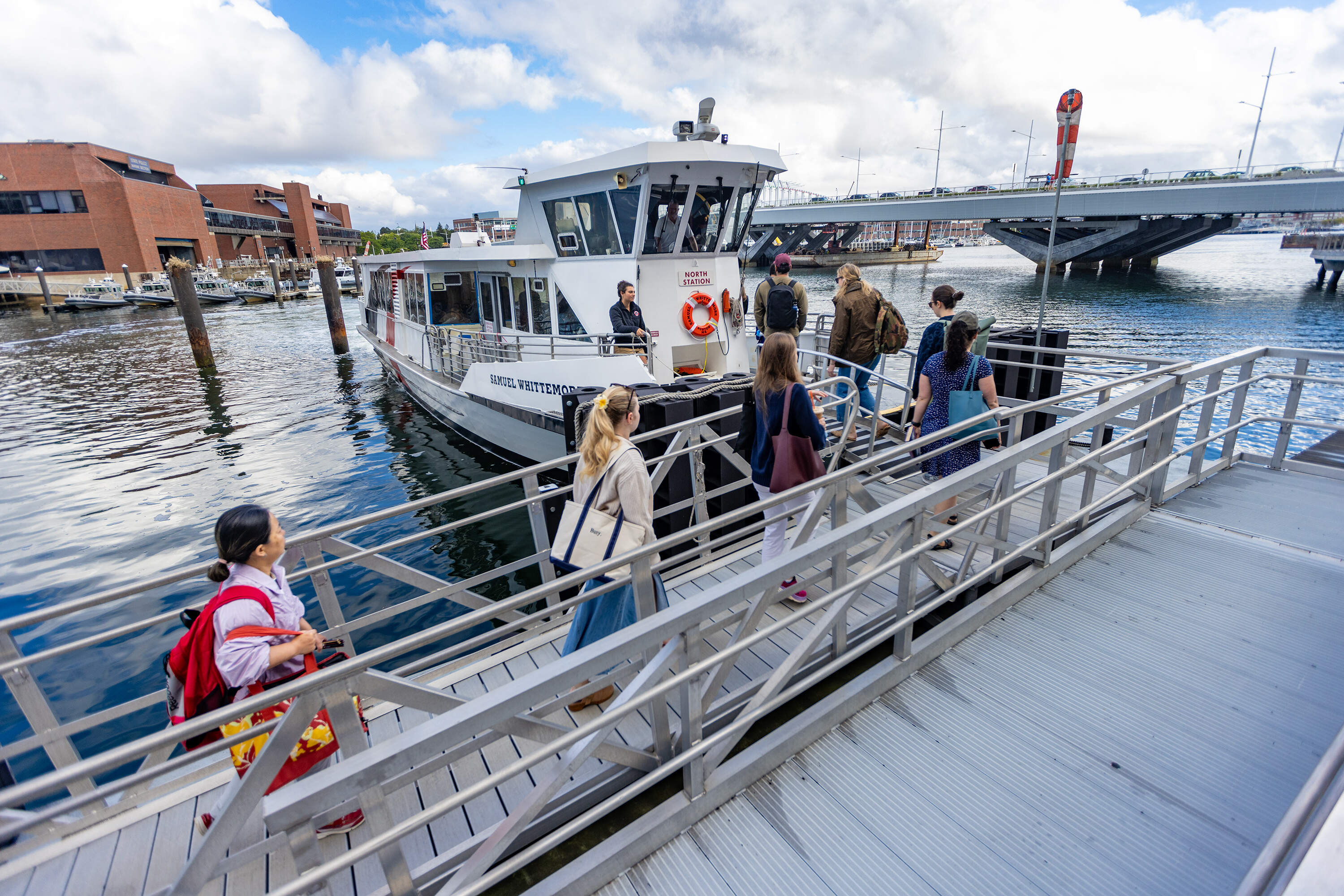 Commuters board the Seaport Ferry, operated by the Massachusetts Convention Center Authority at Lovejoy Wharf in North Station. The ferry route connects North Station with the South Boston waterfront and Fan Pier in the Seaport. (Jesse Costa/WBUR)