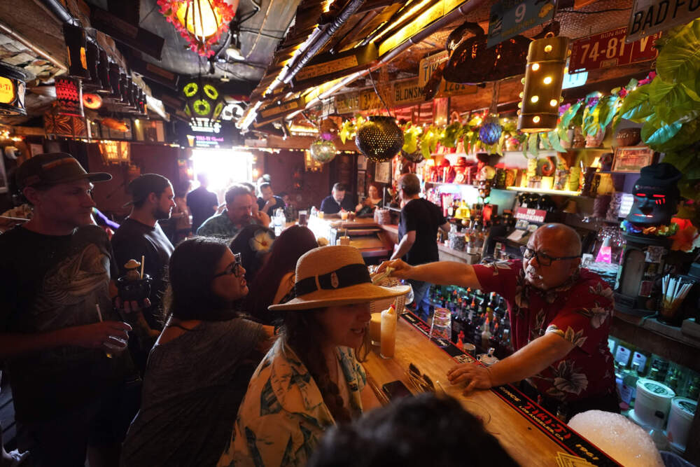 In this July 7, 2021 photo, patrons enjoy tropical cocktails in the tiny interior of the Tiki-Ti bar as it reopens on Sunset Boulevard in Los Angeles. (Damian Dovarganes/AP)