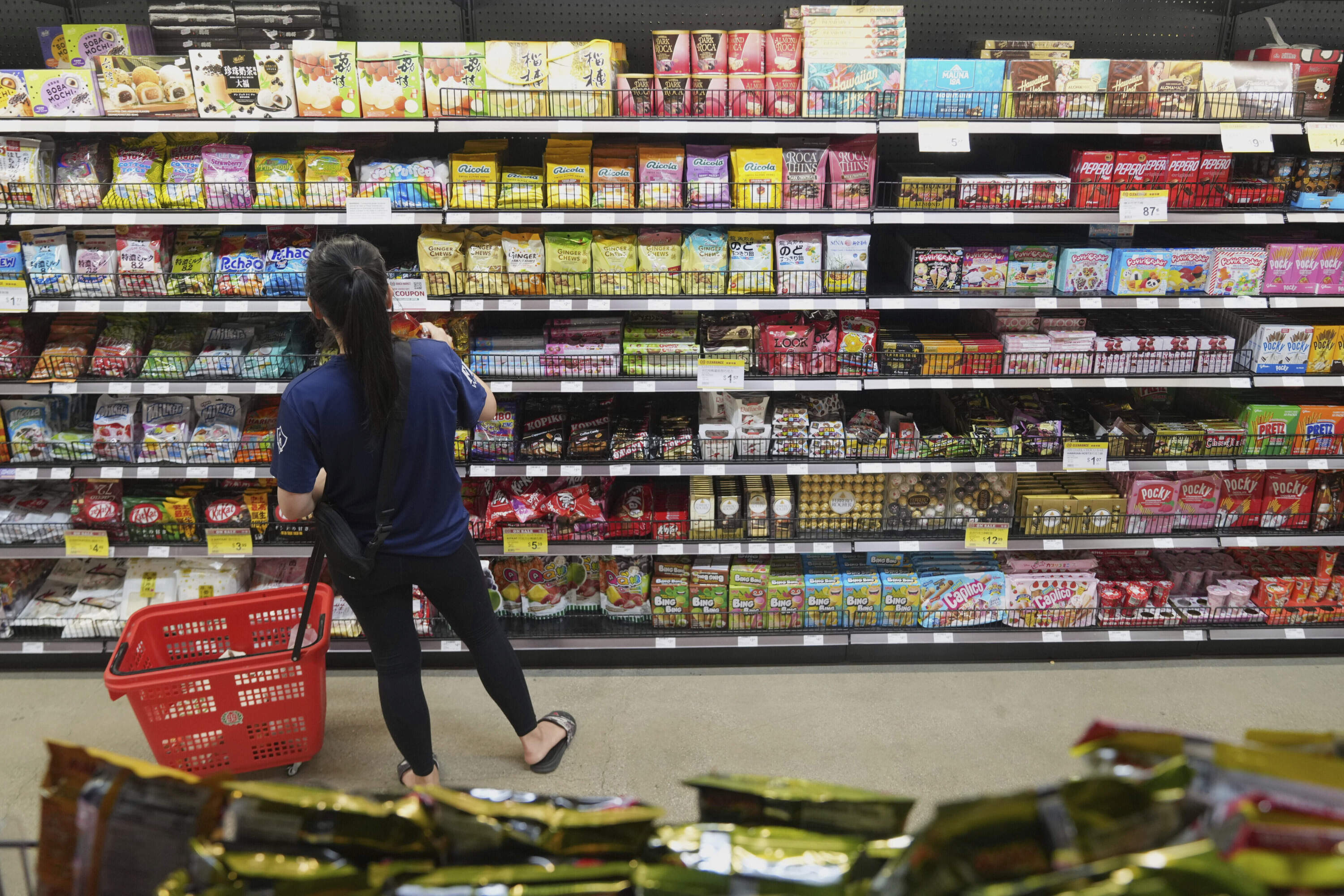A customer buys Chinese made ginger candy at an Asian grocery store in Los Angeles, April 7, 2025. (Damian Dovarganes/AP)