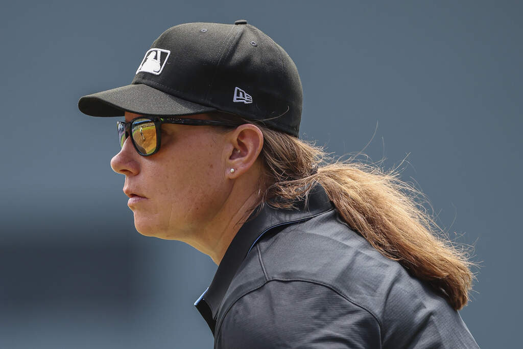 Umpire Jen Pawol, looks on during the first inning of a baseball game of a doubleheader between the Atlanta Braves and Miami Marlins, Saturday, Aug. 9, 2025, in Atlanta. (AP Photo/Colin Hubbard)