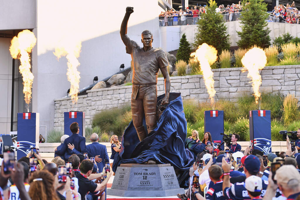 A bronze statue of former New England Patriots quarterback Tom Brady is unveiled in Patriot Place Plaza before an NFL preseason football game between the Washington Commanders and the New England Patriots Friday, Aug. 8, 2025, in Foxborough, Mass. (Steven Senne/AP)