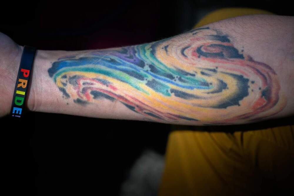 A tattoo on Micah Heumann’s arm shows his support for his trans son Daniel, saying he got it to commemorate his son’s transition “and to remind myself that I have responsibility, even though I'm a cisgender heterosexual male, that I do have a voice that I need to use.” (Mark Mirko/Connecticut Public)