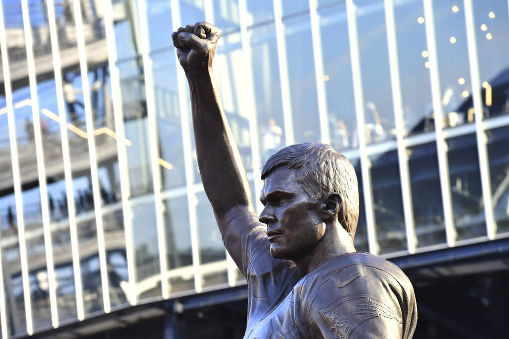 A bronze statue of former New England Patriots quarterback Tom Brady stands in Patriot Place Plaza. (Steven Senne/AP)