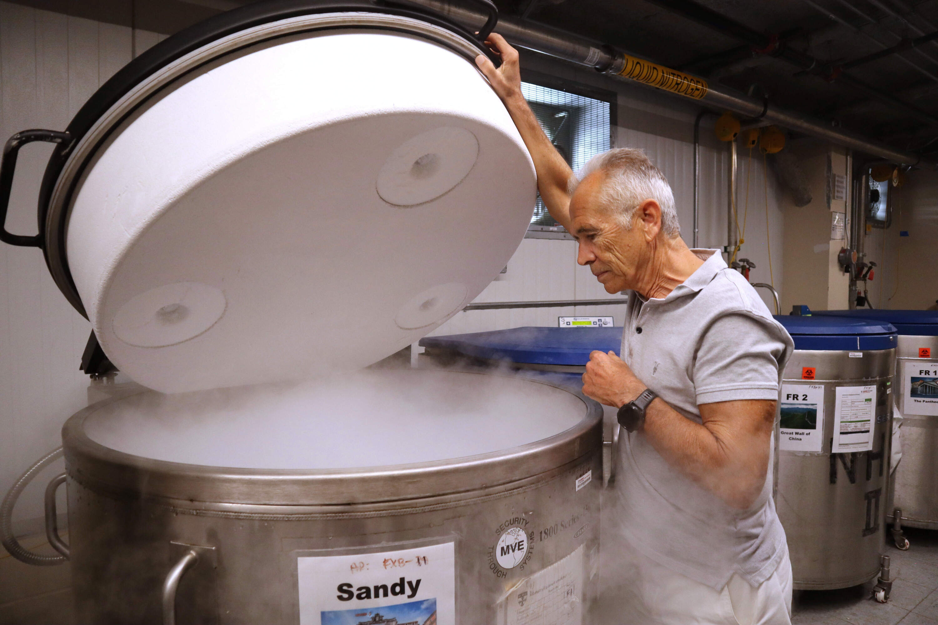 Harvard University professor Alberto Ascherio opens a liquid nitrogen freezer used to store blood samples used for research at the university's T.H. Chan School of Public Health on Tuesday, Aug. 5, 2025 in Boston. (Leah Willingham/AP)