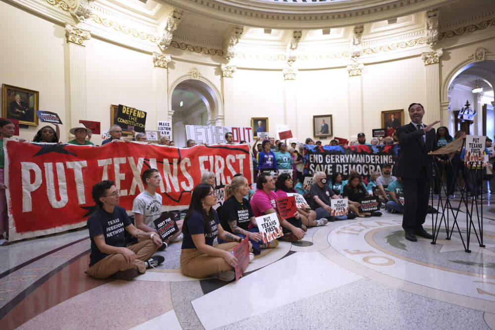 U.S. Congressman Joaquin Castro, right, speaks to protesters gather in the rotunda outside the House Chamber at the Texas Capitol as lawmakers debate a redrawn U.S. congressional map in Texas during a special session, Wednesday, Aug. 20, 2025, in Austin, Texas. (Eric Gay/AP)