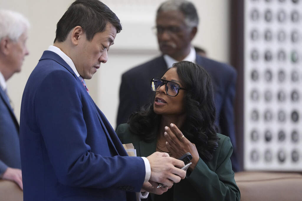 Democratic lawmakers Texas Rep. Gene Wu, left, and Rep. Nicole Collier, right, talk before a debate on a redrawn U.S. congressional map in Texas during a special, Wednesday, Aug. 20, 2025, in Austin, Texas. (Eric Gay/AP)