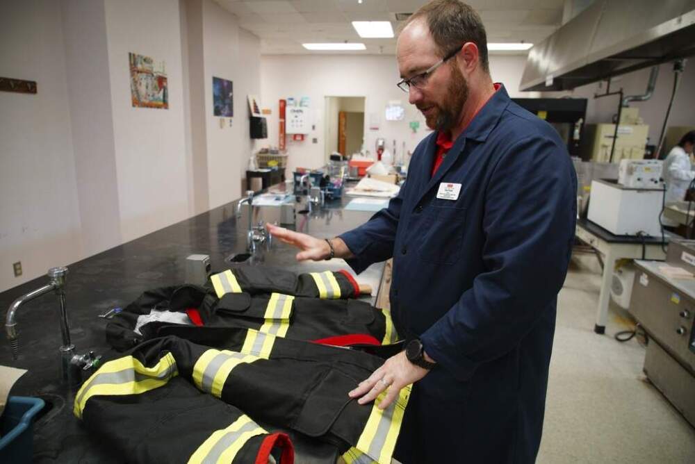 Bryan Ormond, a professor at the Textile Protection and Comfort Center at North Carolina State University, talks about the protective layers in a firefighter jacket on Aug. 8, 2025. (Allen G. Breed/AP)