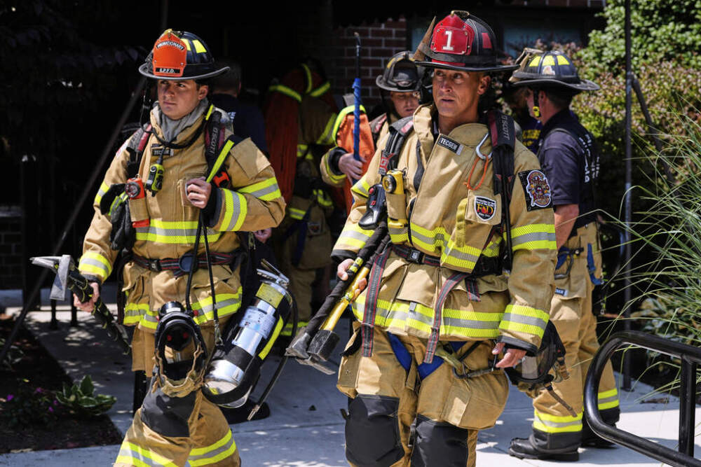 Firefighters respond to a fire while wearing recently issued non-PFAS turnout gear in East Providence. (Charles Krupa/AP)