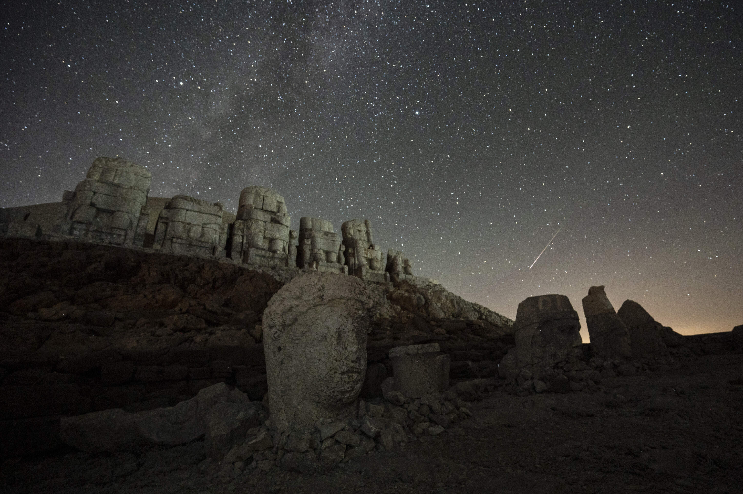 This photo shows the massive stone head sculptures at the archaeological site of Mount Nemrut in Adyaman, southeastern Turkey, on Aug. 11, 2024, the night of the Perseid meteor shower. (Kemal Aslan/AFP via Getty Images)