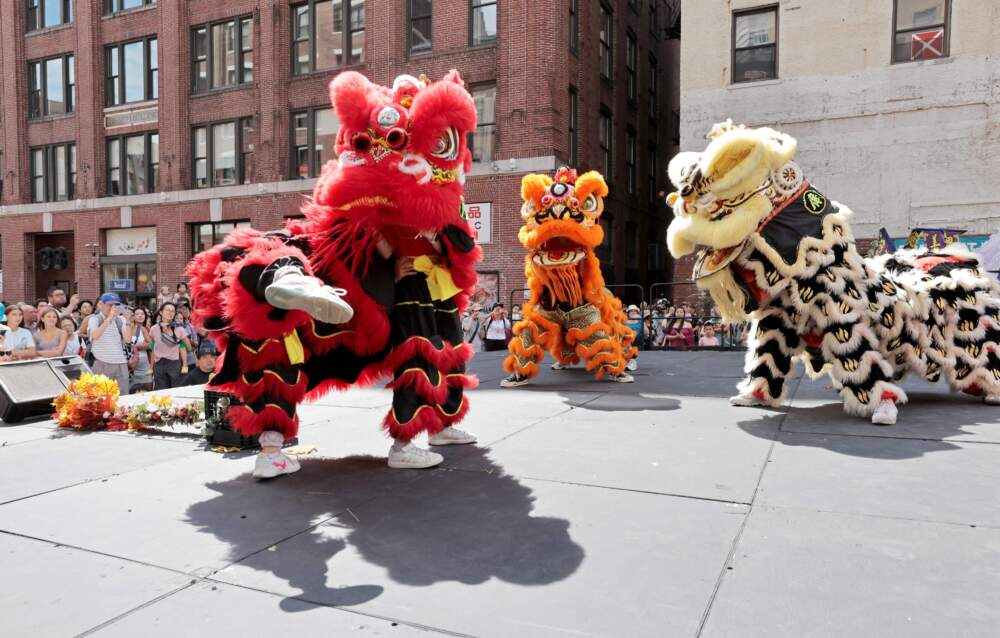 Members of the Kwong Kow Lion Dance group perform on the main stage of the 54th Chinatown August Moon Festival in Boston. (Pat Greenhouse/The Boston Globe via Getty Images)